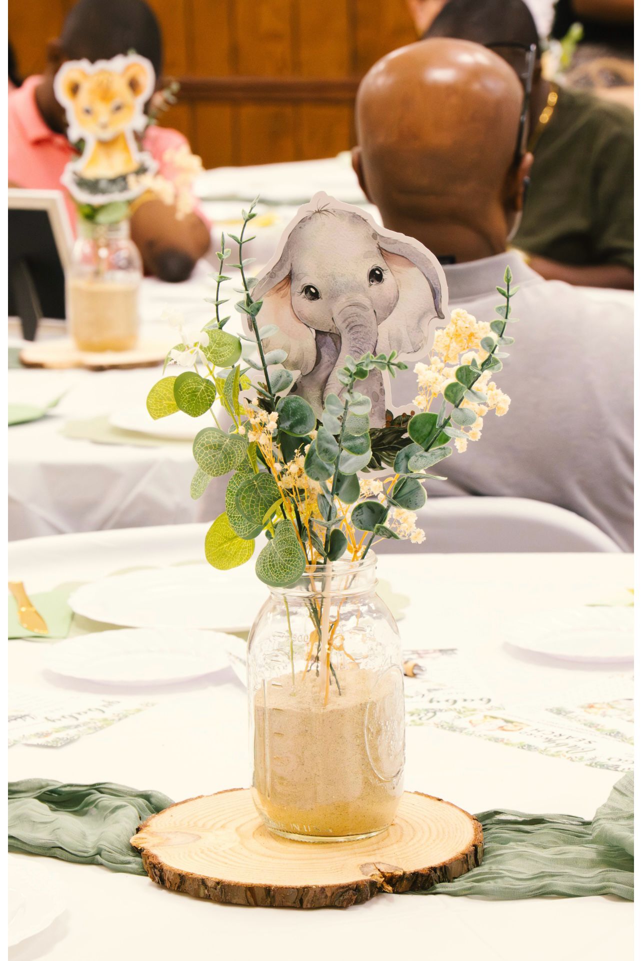 Elephant centerpiece with greenery and wood slice base